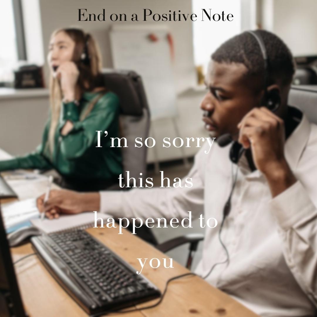 Male call center agent expressing sympathy and taking notes during a customer call