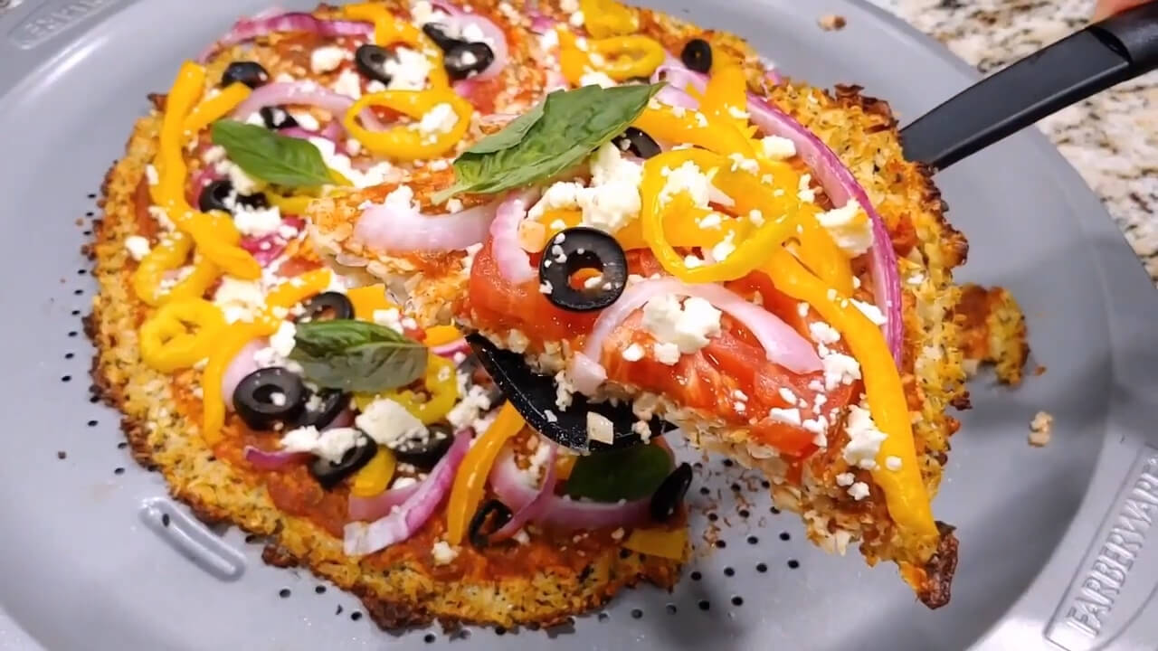 Fresh vegetables placed on a Keto pizza crust