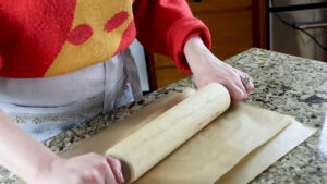 The woman is shaping dough