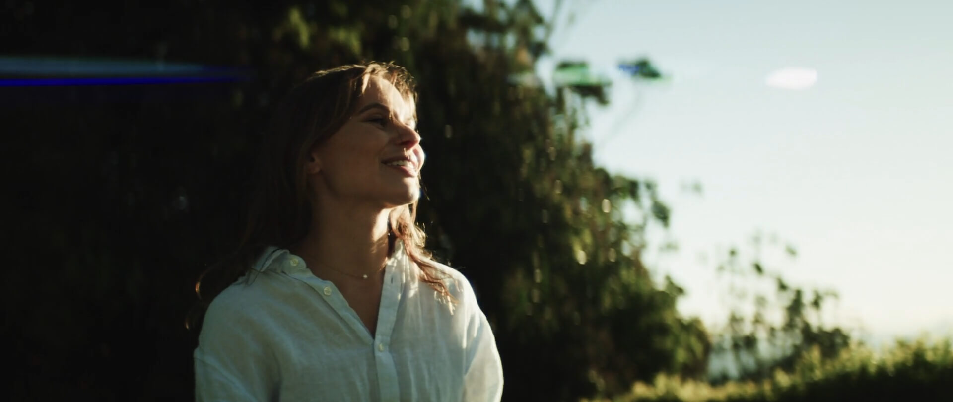 A woman smiling warmly while gazing