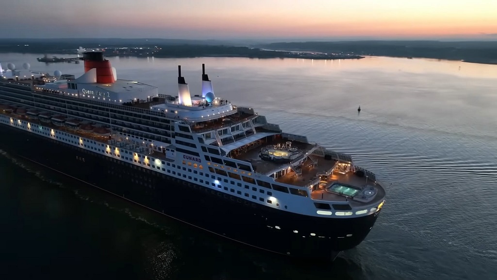 Queen Mary 2 illuminated at sunset