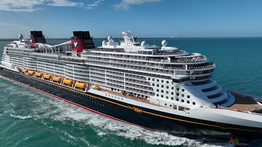 Disney Wish cruise ship with signature Mickey Mouse colors at sea