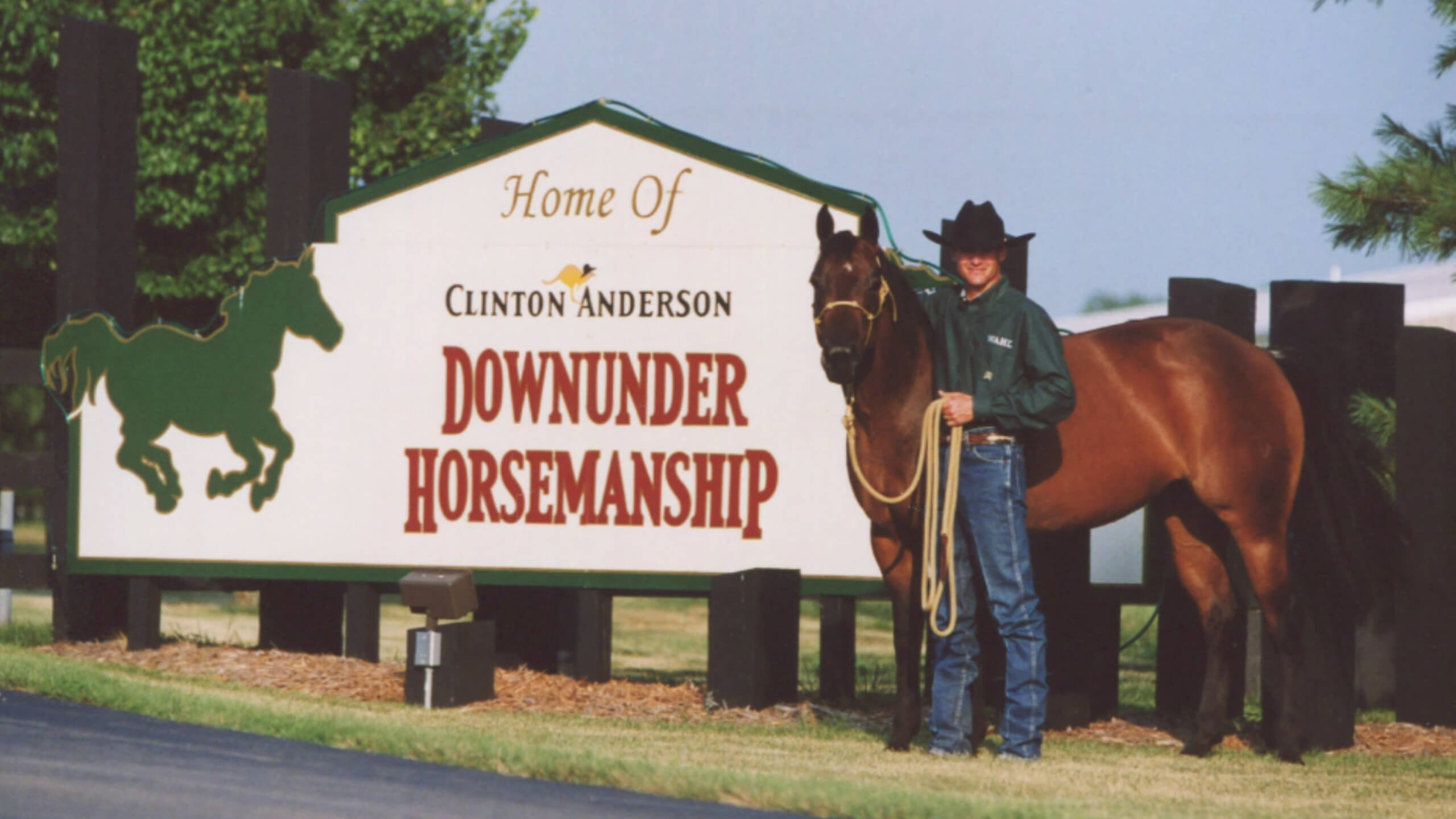 Clinton as a young man in front of the Donwunder Horsemanship sign