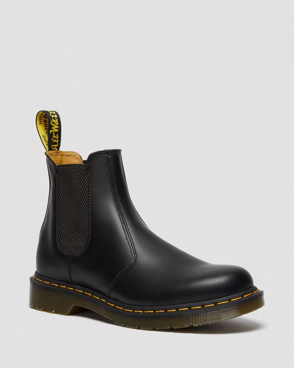 Black leather Dr. Martens Chelsea boot with yellow stitching and pull tab