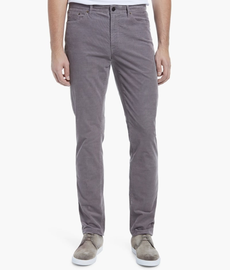 Faherty stretch corduroy pants in grey worn by a male model