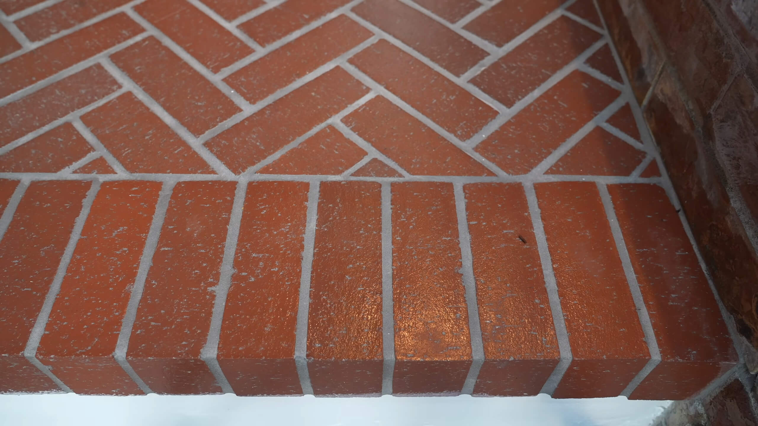 Red bricks arranged in a herringbone pattern