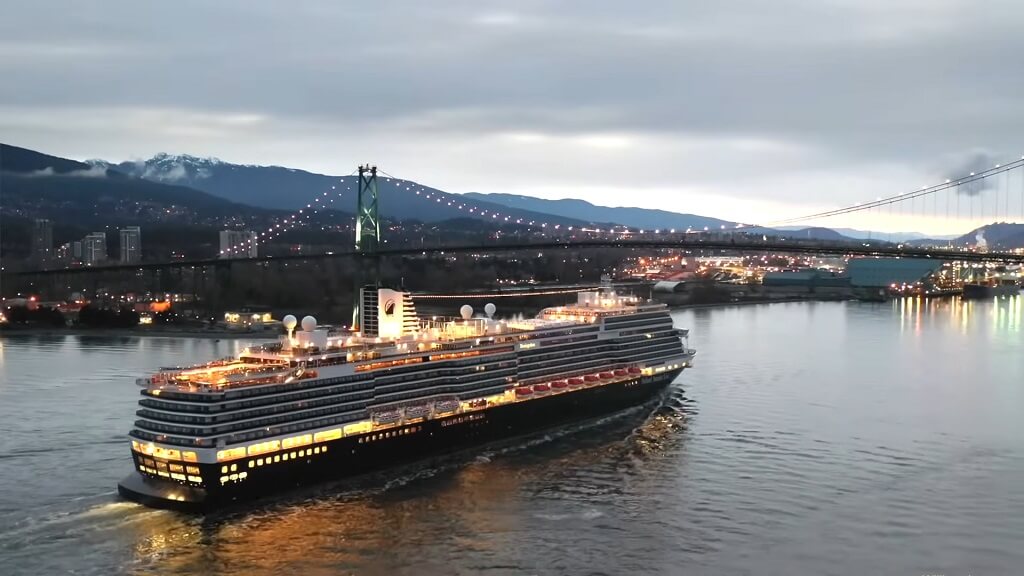 Holland America Line ship sailing near a coastal bridge