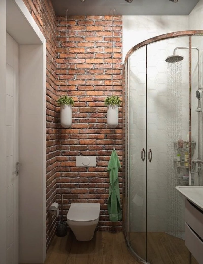 A bathroom with red bricks