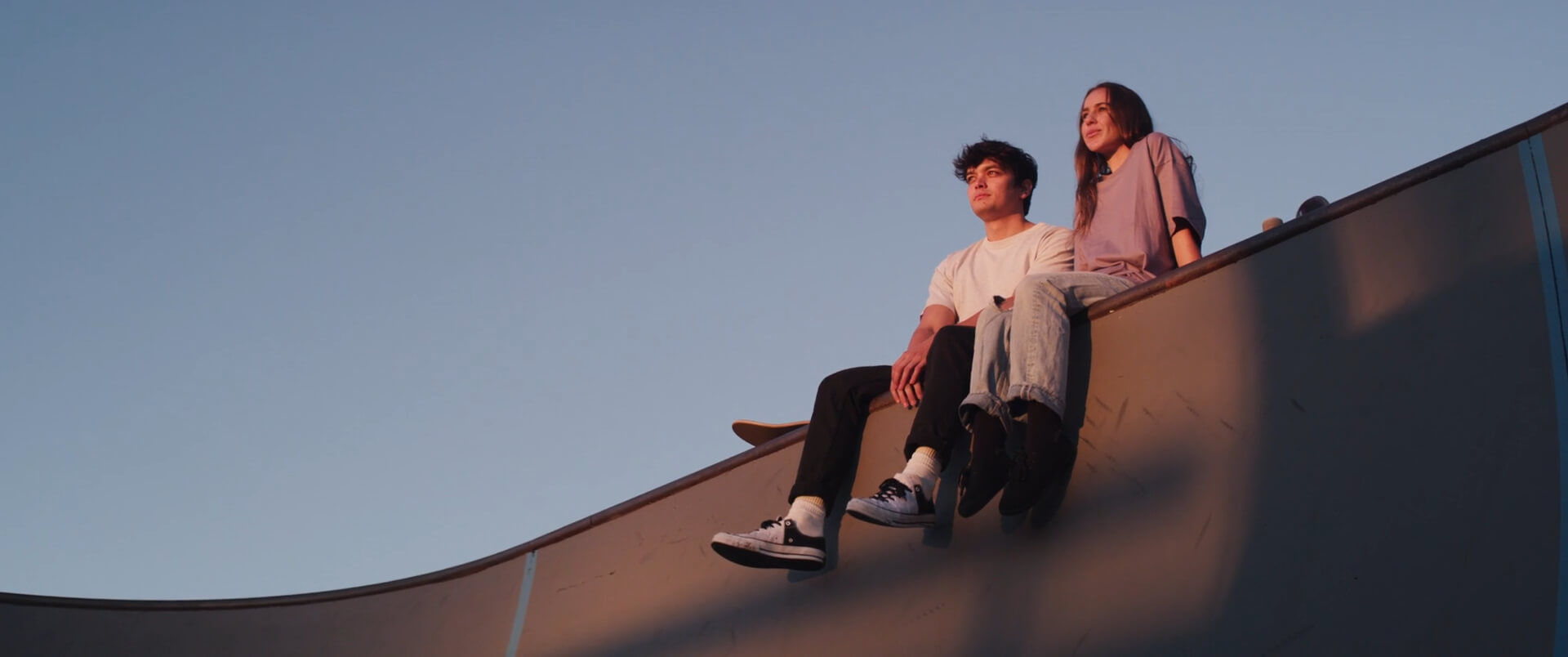 A couple sitting on a ramp together