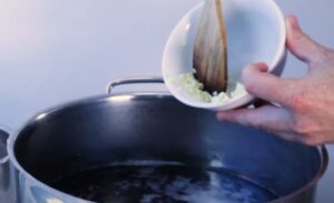 Adding onion to the pot