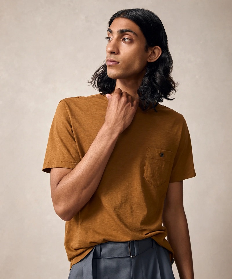 Man wearing a mustard brown short-sleeve Henley shirt