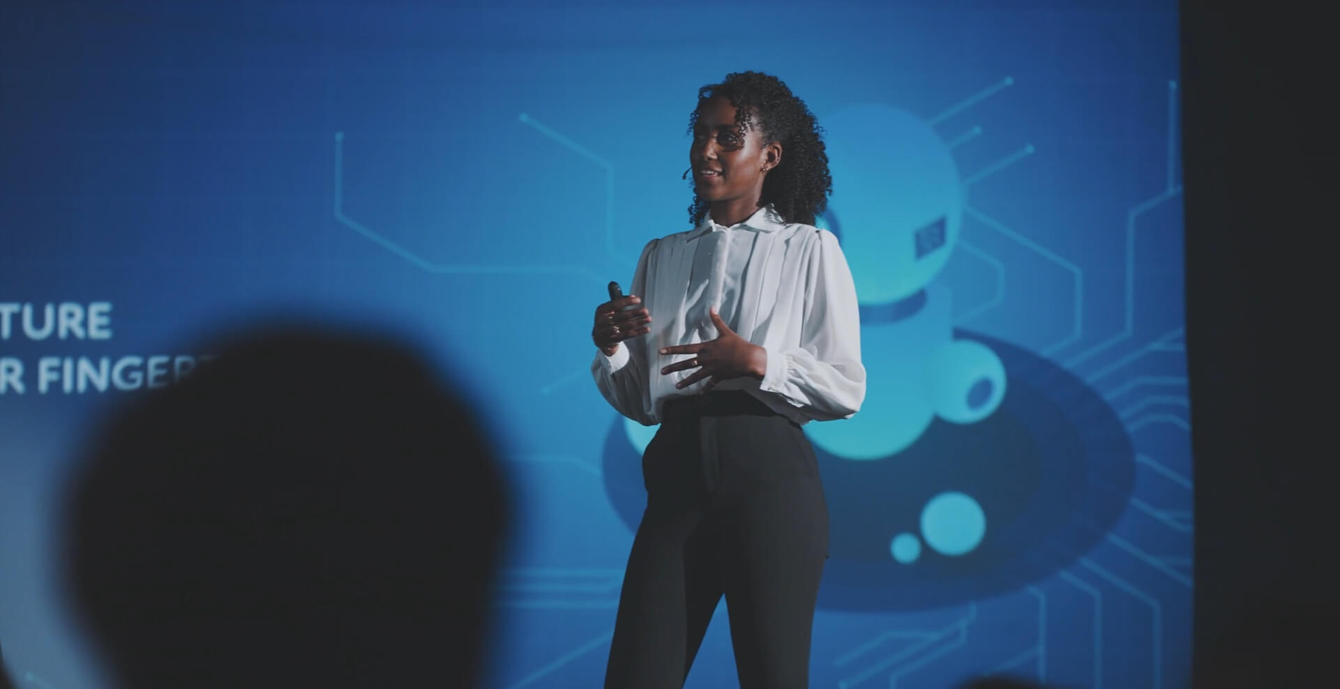 A businesswoman giving a presentation at a conference