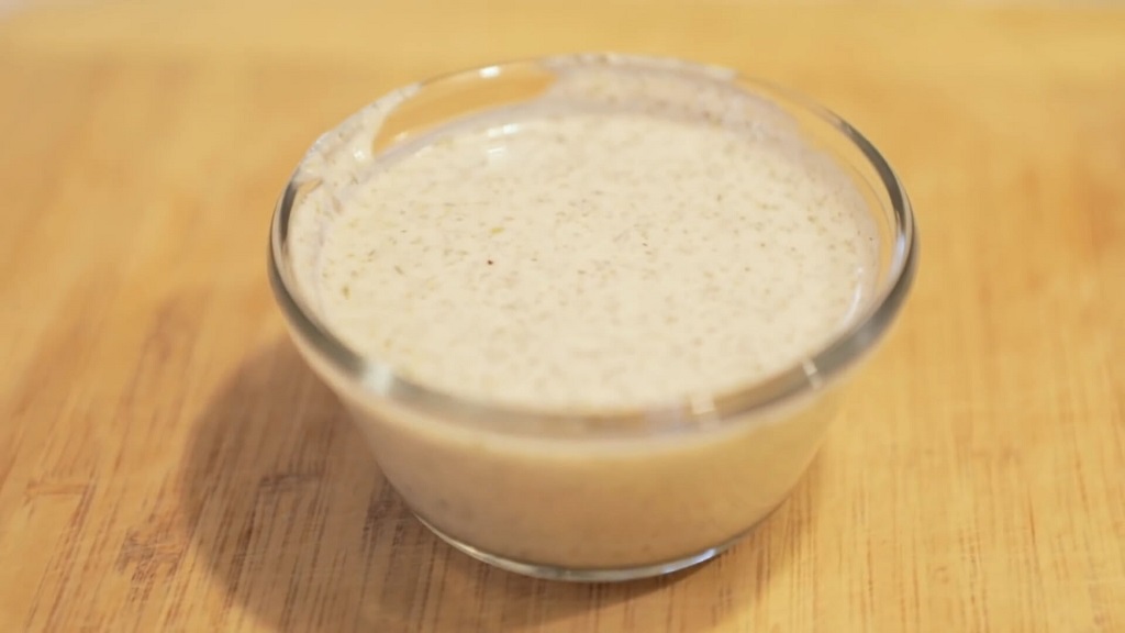 A glass bowl filled with creamy cashew-based ranch dressing