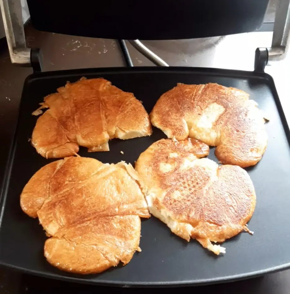 Reheating four croissants in a sandwich press