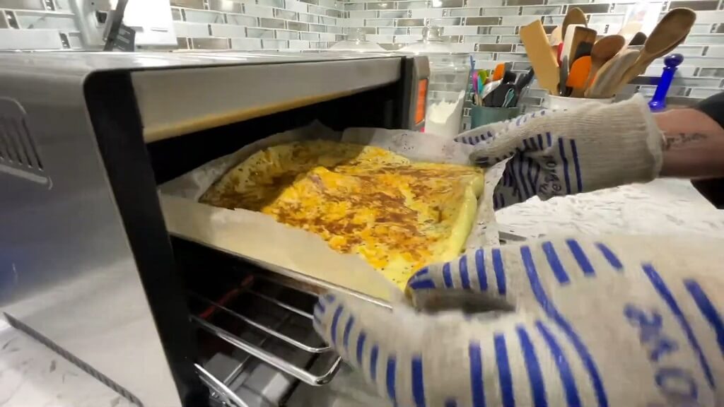 Eggs being reheated in a baking tray in the oven