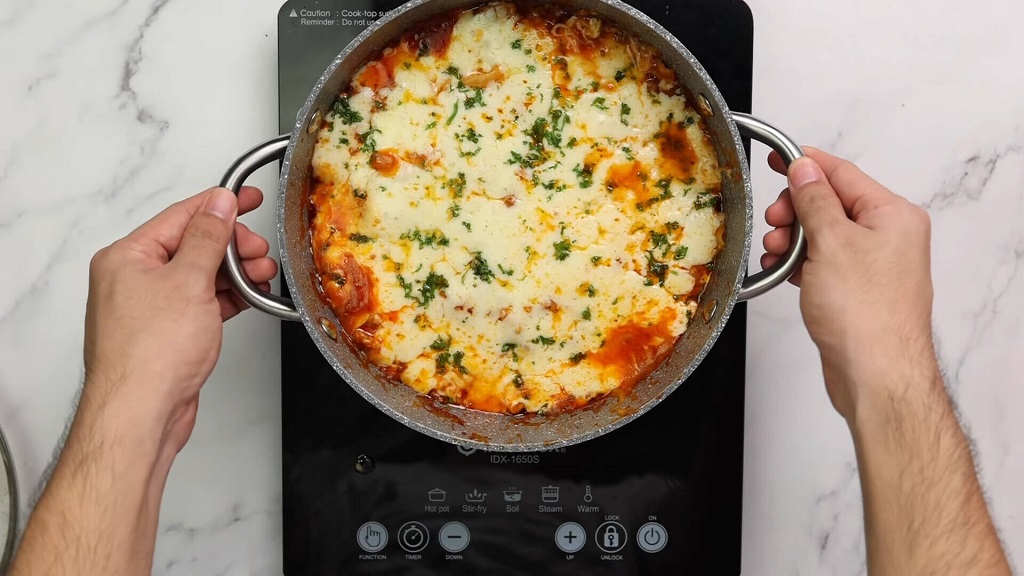 Putting lasagna in a pot on the stovetop