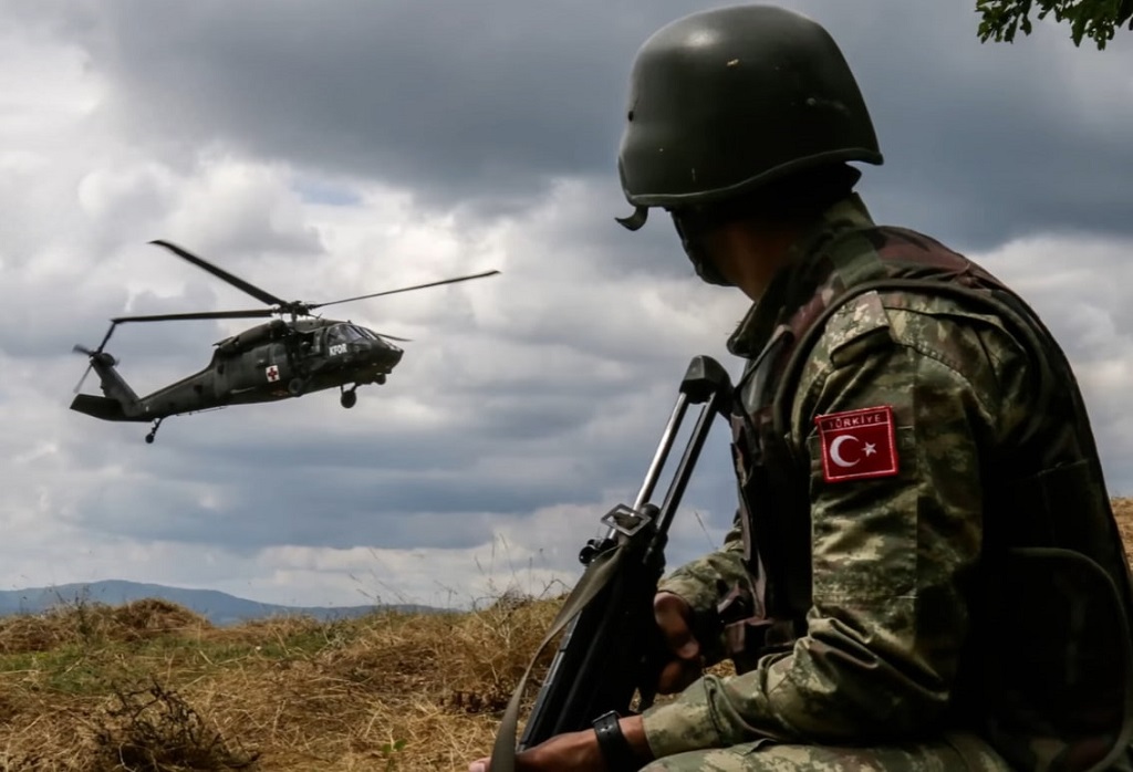 A Turkish soldier looking at a helicopter