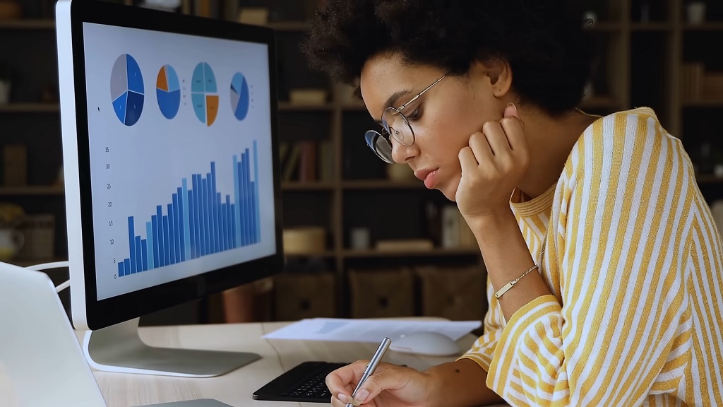 A woman conducting market trend research on her computer