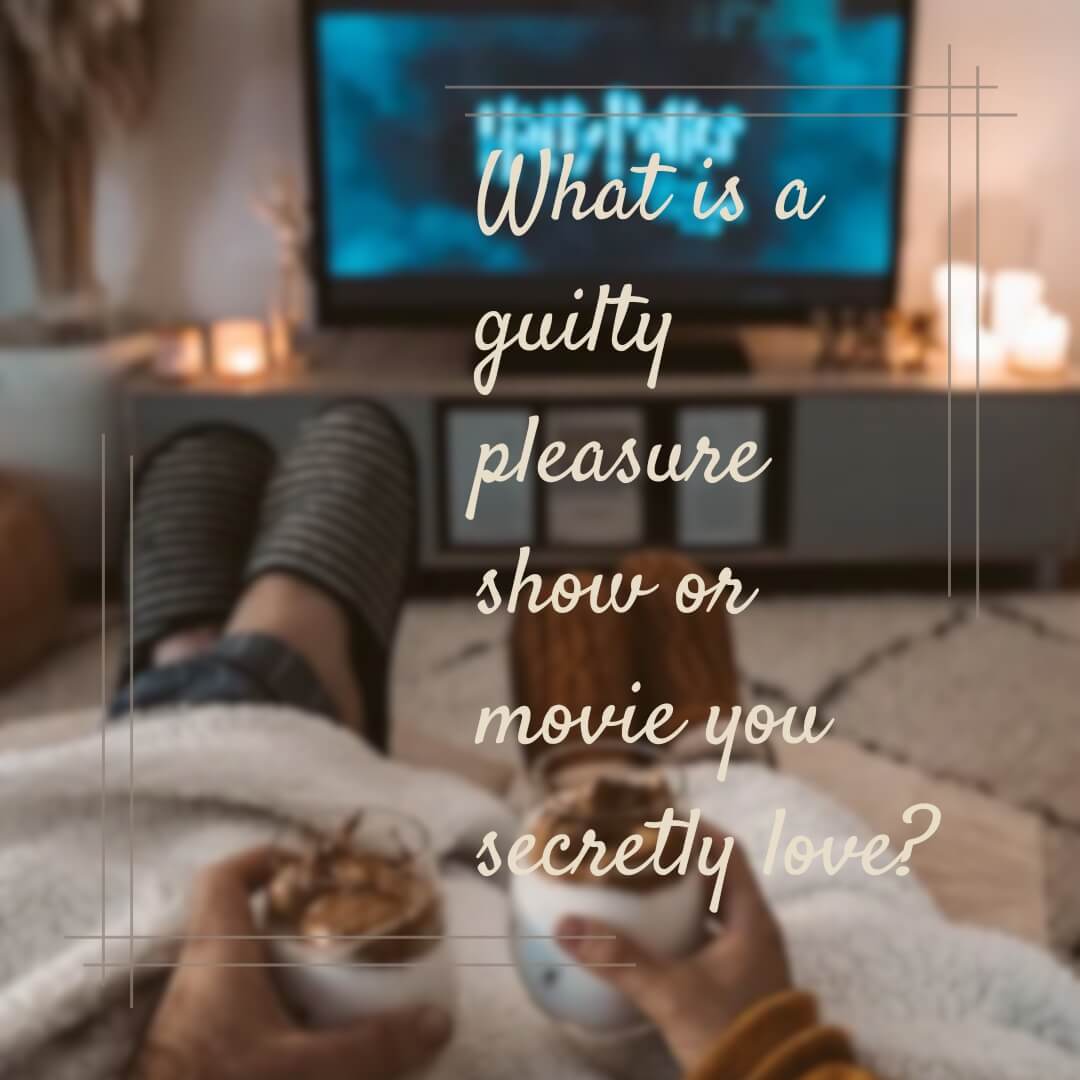 A cozy living room setup with someone’s feet up on the couch, holding hot chocolate, while a TV show plays in the background