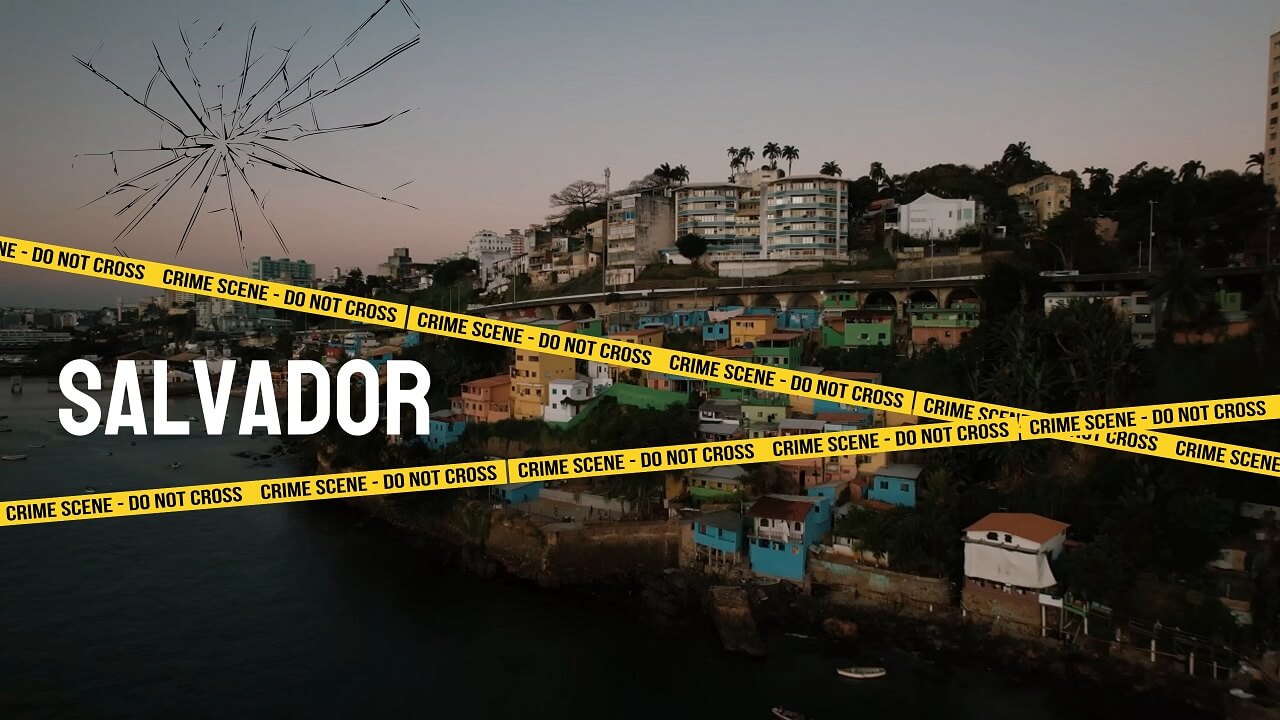 Cityscape of Salvador during dusk, showcasing colorful hillside houses and modern buildings above