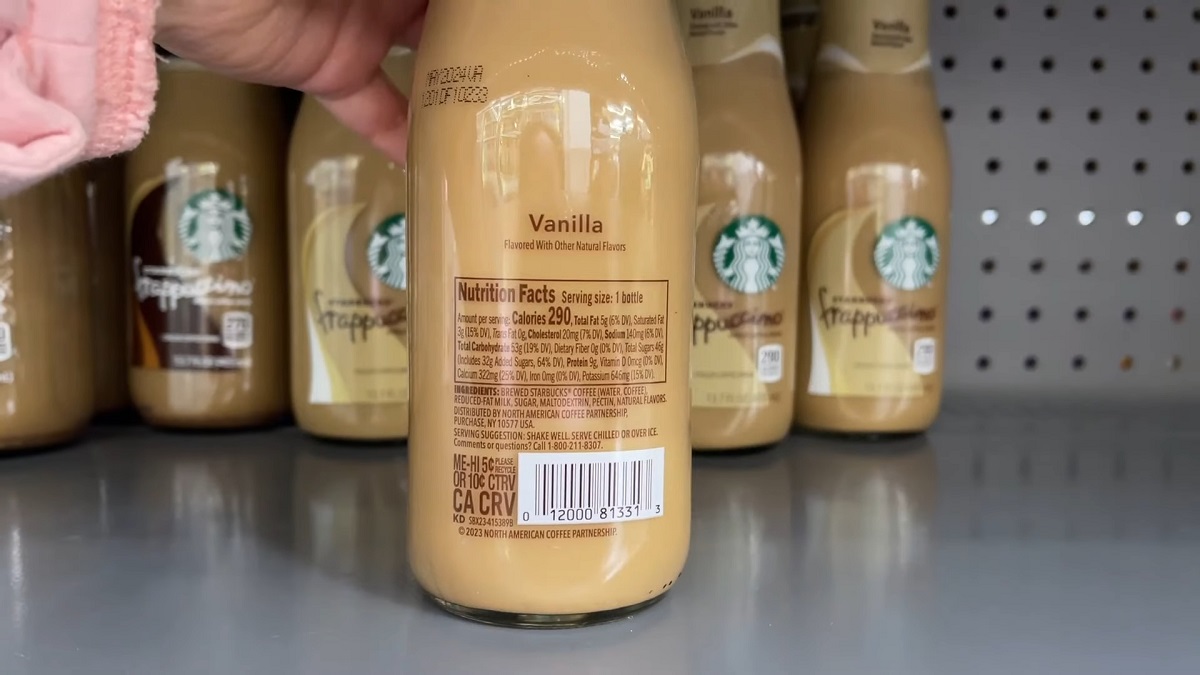 A close-up of a Starbucks Vanilla Frappuccino bottle showing the nutrition facts, with a focus on its calorie content and ingredients