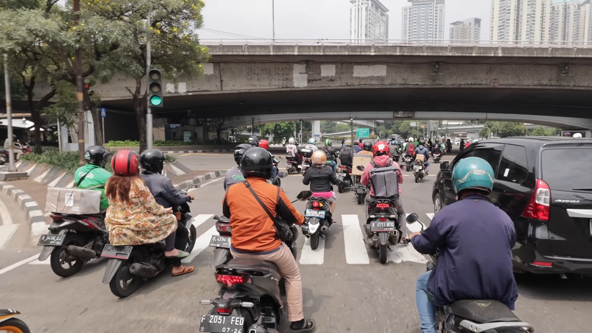 A busy street in Indonesia with motorbikes and scooters