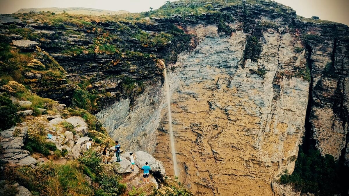 A breathtaking view of a waterfall cascading down a massive cliff in Chapada Diamantina, Brazil