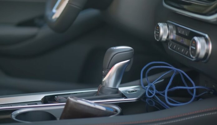 Dark interior of the Nissan Altima, with a metallic gear shift