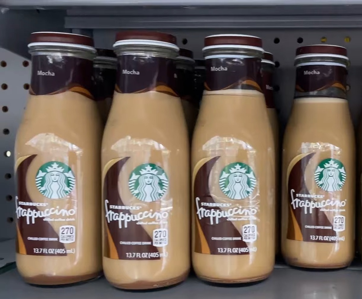  A shelf displaying multiple bottles of Starbucks Mocha Frappuccino, a chilled coffee drink