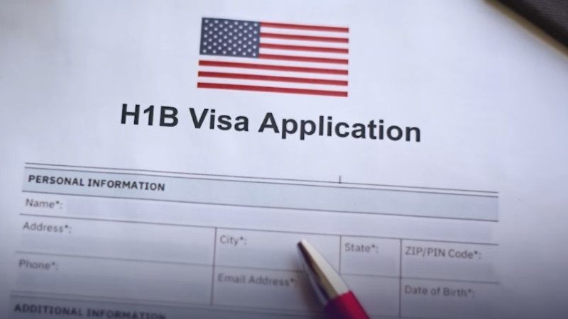 H1B visa application form with a pen placed on top