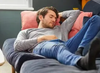 A guy napping on a bed.