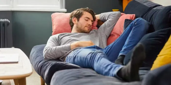 A guy napping on a bed.