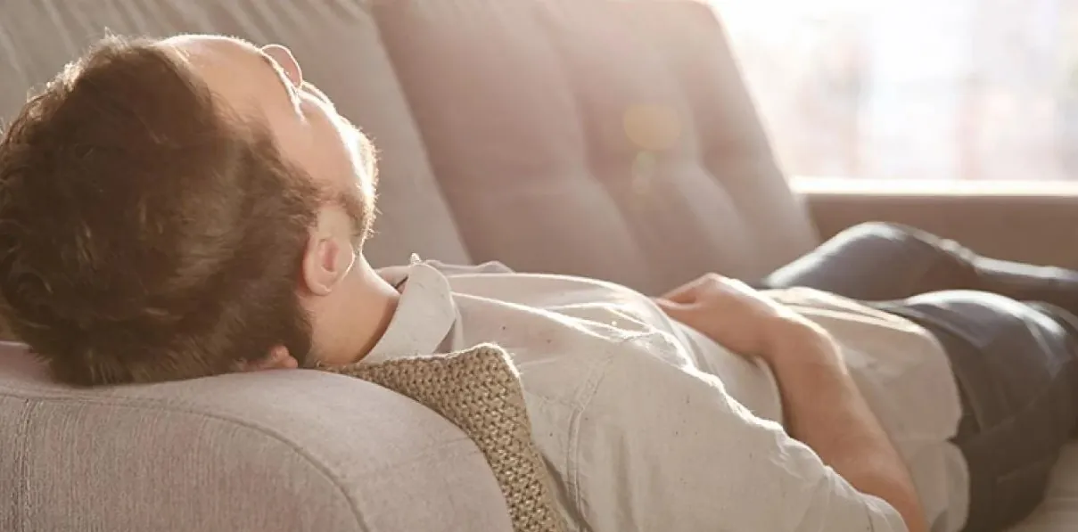 A guy taking a nap and celebrating National Napping Day